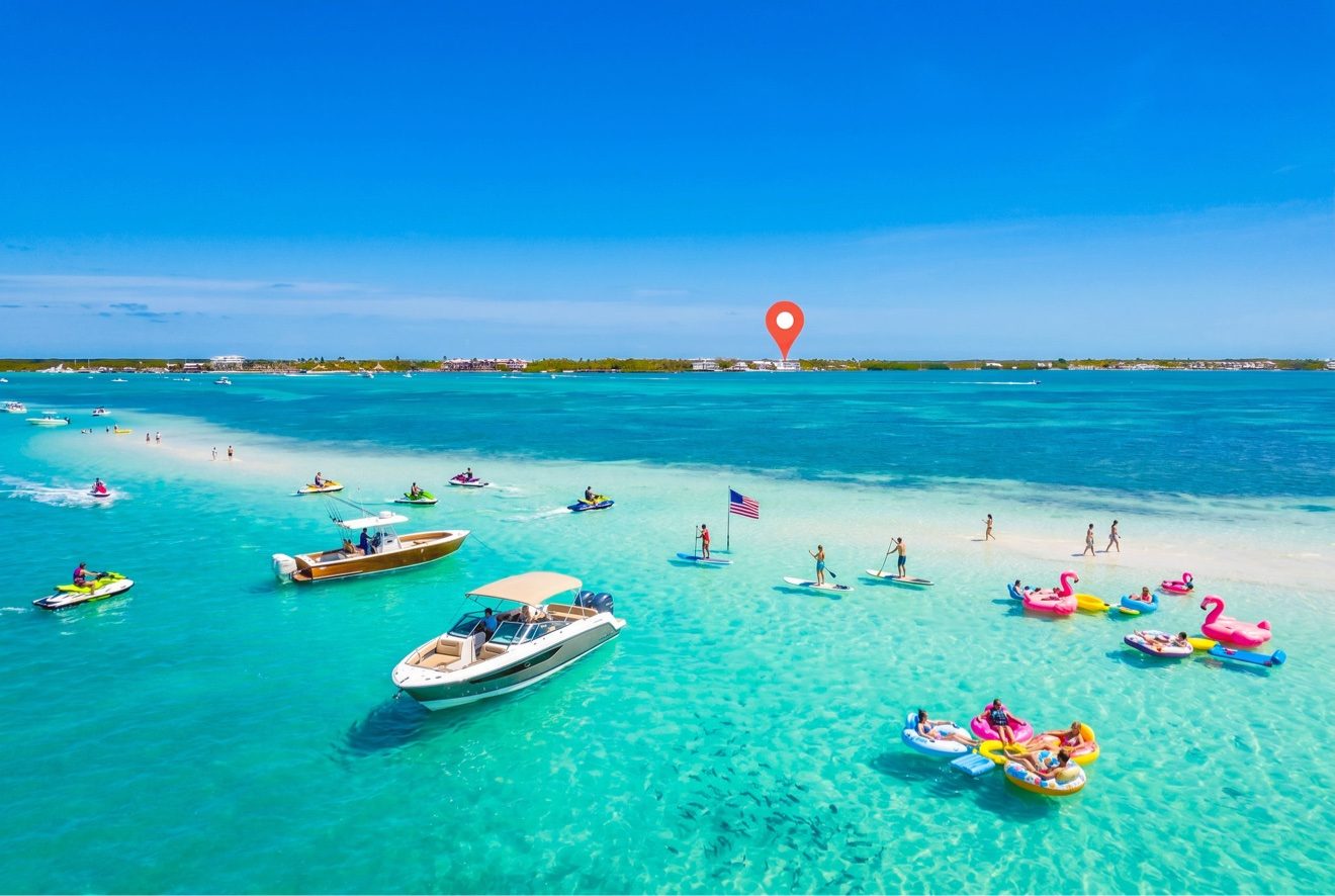 Aerial view of a sandbar near Islamorada with boats, paddle boards, and floats on turquoise water