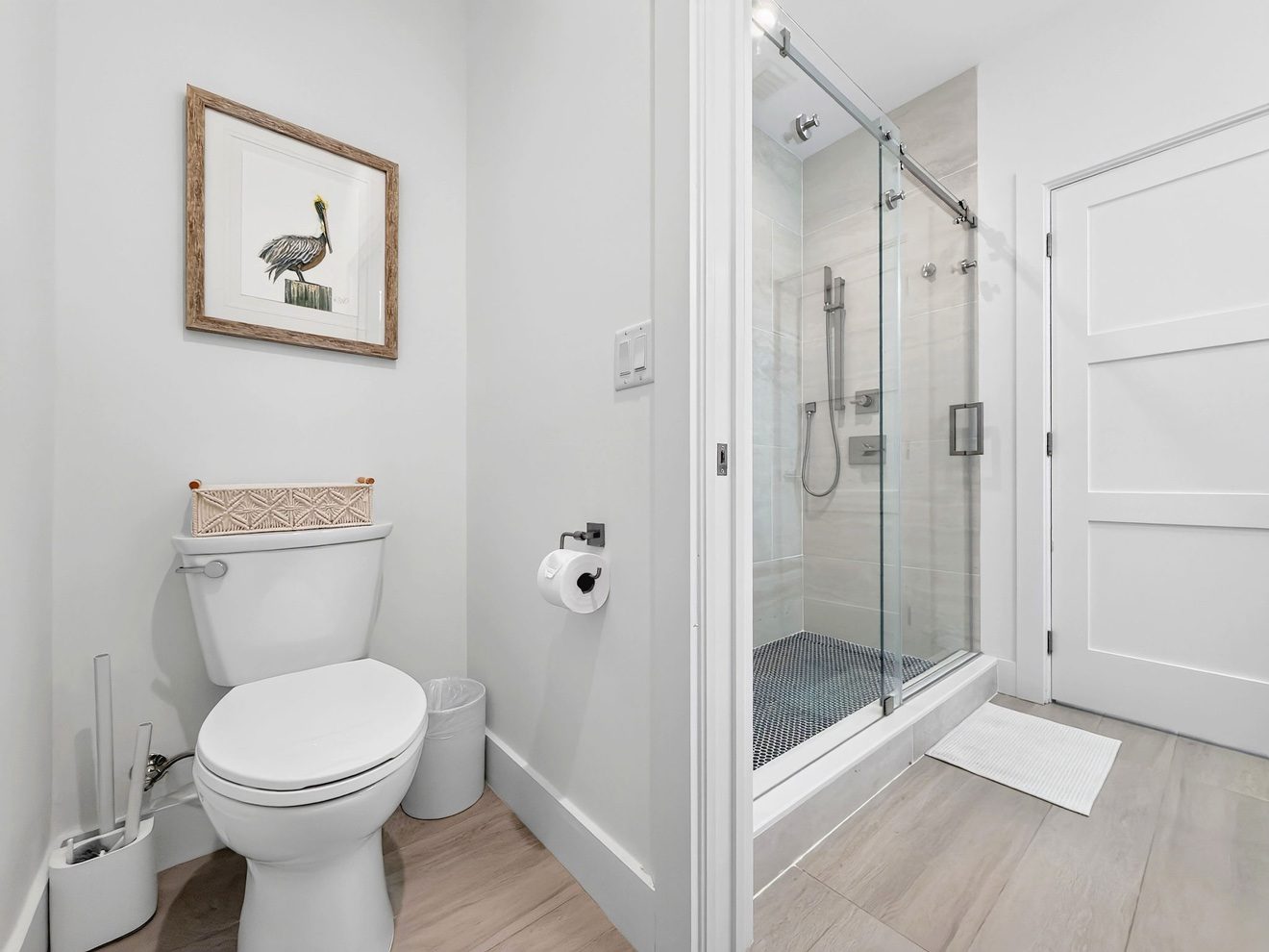 Bathroom with toilet and glass-enclosed shower