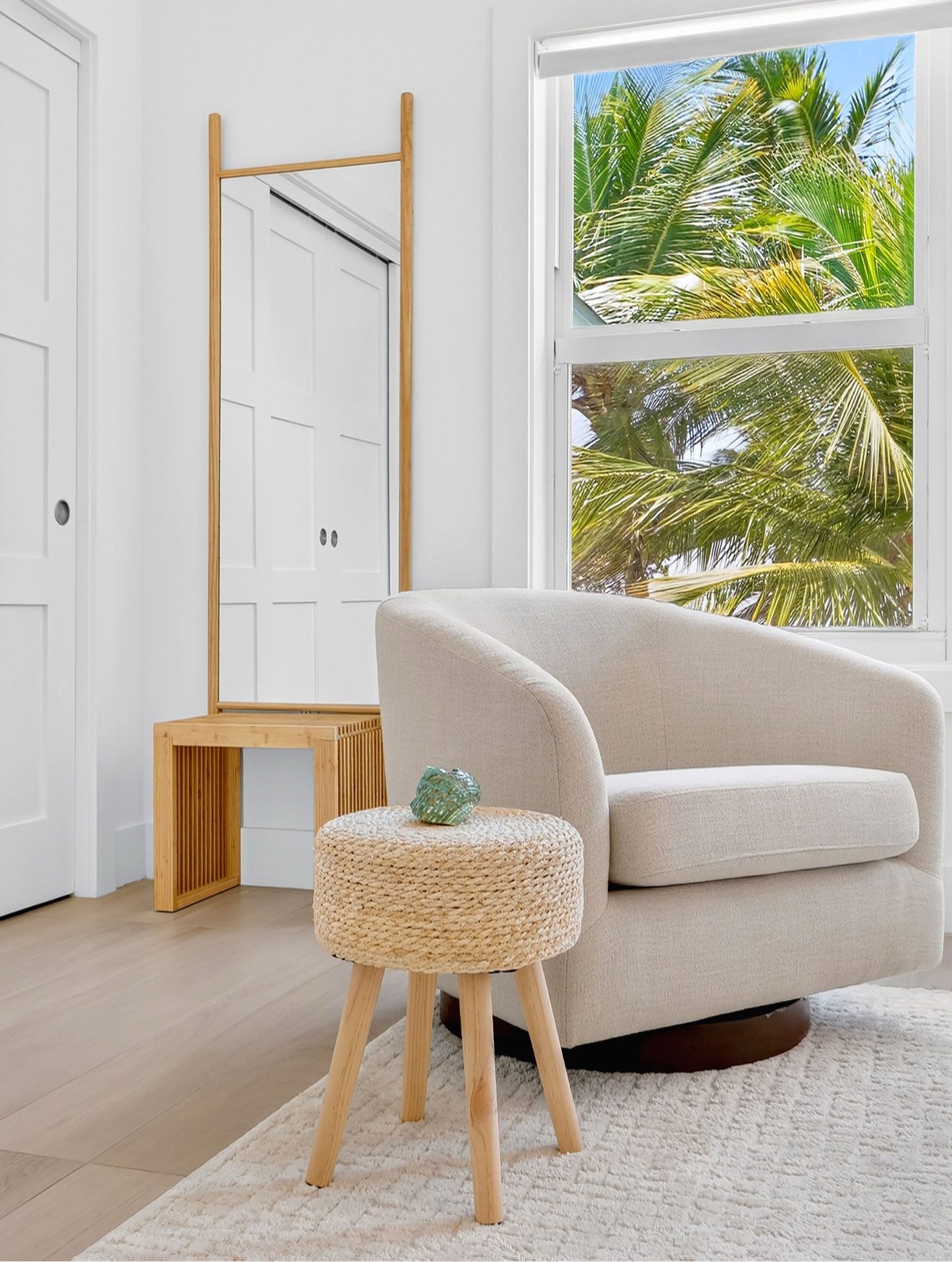 Bedroom sitting corner with armchair and palm views
