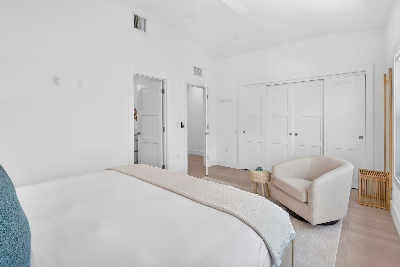 Bright guest bedroom with king bed and seating area