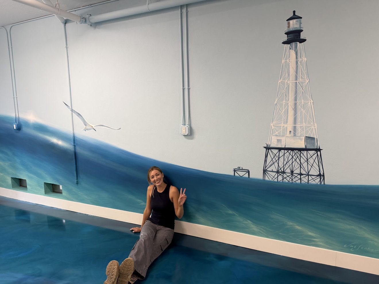 Hand-painted lighthouse and ocean mural in the game room